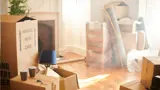 A living room with items waiting to be unpacked.