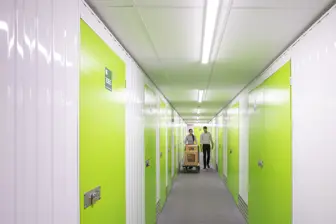 People walking through corridor of self storage units