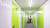 People walking through corridor of self storage units