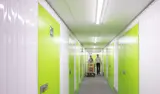 People walking through corridor of self storage units