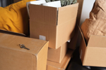 Moving boxes packed and stacked on a sofa
