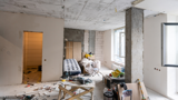 Furniture stored in the corner of a room during a house renovation