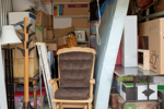 Items loaded into a storage unit including a rocking chair and coat hanger