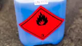 Bottle of liquid with a flammable warning sticker. 